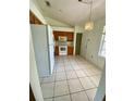 Kitchen with white appliances, tiled floors, and wooden cabinetry offer ample cooking and storage space at 5230 Clarion Oaks Dr, Orlando, FL 32808