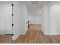 Bright hallway with wood floors leading to an open living area, showcasing the home's spacious layout at 6522 Rover Way, St Cloud, FL 34771