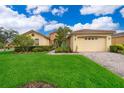 Charming home featuring a lush green lawn and inviting curb appeal at 730 Villa Park Rd, Poinciana, FL 34759