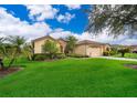 Attractive home with a manicured lawn and mature landscaping at 730 Villa Park Rd, Poinciana, FL 34759