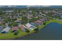 Aerial view of property showcasing lakeside lot and backyard pool with enclosed patio at 746 Stonewyk Way, Kissimmee, FL 34744