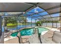 Relaxing screened-in pool area with a view of the lake, perfect for entertaining at 746 Stonewyk Way, Kissimmee, FL 34744