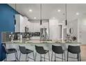 Kitchen bar with modern chairs and lighting fixtures at 9126 Sommerset Hills Dr, Davenport, FL 33896
