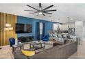Beautiful living room with blue accent wall and a view of the kitchen and dining area at 9126 Sommerset Hills Dr, Davenport, FL 33896
