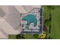 Aerial view of a home's unique shaped pool and screened-in enclosure surrounded by lush green landscaping at 9905 Lanai View Ct, Windermere, FL 34786