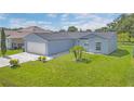 Well-maintained single-story home with a green lawn and fresh landscaping at 107 Whitehall Way, Kissimmee, FL 34758