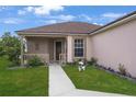 Charming front porch with a cozy, covered entrance and decorative landscaping at 1197 E Grove Ave, Lake Wales, FL 33853