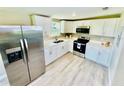 This modern kitchen is complete with stainless steel appliances and stylish white cabinets and countertops at 13 E 8Th St, Frostproof, FL 33843