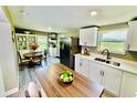 Eat-in kitchen featuring stainless steel appliances, white cabinets, and a breakfast nook at 13 E 8Th St, Frostproof, FL 33843