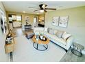 Bright and airy living room with modern furniture, a ceiling fan, and views into the kitchen at 13 E 8Th St, Frostproof, FL 33843
