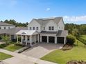 Beautifully landscaped home with a three-car garage and a charming front porch perfect for relaxing outdoors at 14081 Gullstrand Ave, Orlando, FL 32827