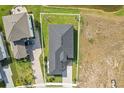 An aerial view of a gorgeous home with a dark roof, manicured lawn and brick driveway at 224 Valencia Ridge Dr, Auburndale, FL 33823
