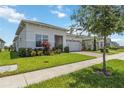 Lovely single-story home showcasing a well-kept lawn, lush landscaping, and a brick driveway at 2621 Redblush Ter, St Cloud, FL 34772
