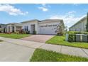 Well-kept single Gathering home features a brick paver driveway and attached two-car garage at 2621 Redblush Ter, St Cloud, FL 34772