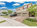 Inviting two-story home featuring a brick driveway and a two-car garage at 2690 Pleasant Cypress Cir, Kissimmee, FL 34741