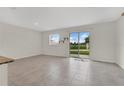 Bright living room area with tile flooring and a large sliding glass door to the backyard at 2690 Pleasant Cypress Cir, Kissimmee, FL 34741