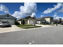 Attractive street view showcases the home's neat landscaping and well-maintained facade, adding to its appeal at 2727 Harmonia Hammock Rd, Harmony, FL 34773