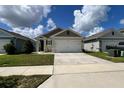 Beautifully landscaped front yard features green grass and tasteful plantings, enhancing the home's curb appeal at 2727 Harmonia Hammock Rd, Harmony, FL 34773