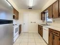 Well-lit kitchen featuring wood cabinets, white countertops, and essential appliances, providing functionality at 430 Short Dr, Kissimmee, FL 34759