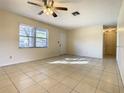 Inviting living room with tile floors, a ceiling fan, and natural light, creating a cozy atmosphere at 430 Short Dr, Kissimmee, FL 34759
