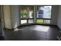 Bright living room with sleek tile flooring and large windows overlooking lush greenery at 4378 Aqua Vista Dr # L, Orlando, FL 32839