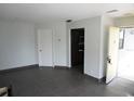 Open-concept living room with tile floors, neutral walls, and doorway to kitchen at 4378 Aqua Vista Dr # L, Orlando, FL 32839