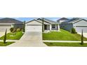 Beautiful single-story home with a manicured lawn and a two car garage at 4501 Hummingbird Ln, Haines City, FL 33844