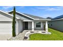Inviting front porch features stylish stone landscaping and a covered entrance at 4501 Hummingbird Ln, Haines City, FL 33844
