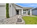 Close up of stylish stone landscaping with covered entry and house number at 4501 Hummingbird Ln, Haines City, FL 33844