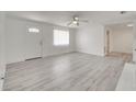 Open-concept living area with a front door view, light gray flooring, and a ceiling fan at 4521 Alrix Dr, Orlando, FL 32839