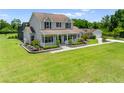 Beautiful two-story home showcasing a spacious lawn and charming front porch at 4551 Hunting Lodge Dr, St Cloud, FL 34772