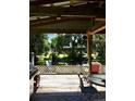 Inviting covered patio offers a relaxing waterfront view with outdoor seating and a grill at 5019 Pineapple St, Lake Wales, FL 33898