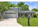 Attractive home with well-kept lawn, solar panels, and a mailbox adding to the curb appeal at 878 Elgin Dr, Winter Springs, FL 32708