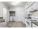 Bright kitchen with white cabinets, laminate countertops, new appliances, and a washer/dryer closet at 911 N Orange Ave # 321, Orlando, FL 32801