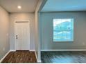 Welcoming entryway featuring wood-look tile flooring, a white front door, and a large window at 1343 Lassen St, Haines City, FL 33844