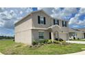 Charming two-story home featuring neutral stucco, black shutters, and well-maintained landscaping at 1343 Lassen St, Haines City, FL 33844