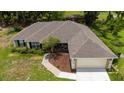 A high angle shot showing the roof and garage of a charming single-story home at 1405 Ashbury Ct, Lakeland, FL 33809