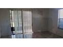Living room with tiled floor, sliding glass doors to patio and a window at 2002 Cascades Blvd # 108, Kissimmee, FL 34741