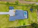 Aerial view of a beautiful home with a swimming pool, well-manicured lawn, and surrounding greenery at 20414 Quinn St, Orlando, FL 32833