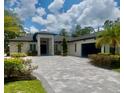 Elegant home exterior with well-maintained landscaping, a paved driveway, and a welcoming entrance at 20414 Quinn St, Orlando, FL 32833