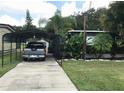 Long driveway with covered parking area, leading to the home and providing ample space at 2082 Starboard Dr, Geneva, FL 32732