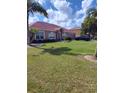 Inviting home exterior boasting a verdant lawn, manicured bushes, and convenient driveway parking at 2357 Great Harbor Dr, Kissimmee, FL 34746