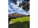 Side view of a single Gathering home with a manicured lawn and ample backyard space at 2357 Great Harbor Dr, Kissimmee, FL 34746