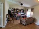 Cozy living room featuring wood-look tile flooring and a comfortable seating area at 2357 Great Harbor Dr, Kissimmee, FL 34746