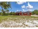 A single-story home with solar panels, a deck, and a large grassy yard at 2576 R E Byrd Rd, Frostproof, FL 33843