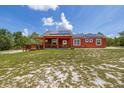 Charming single-story home with solar panels, a wooden deck, and a large front yard at 2576 R E Byrd Rd, Frostproof, FL 33843