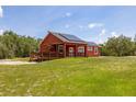 A beautiful single-story home with a wooden deck and solar panels on the roof at 2576 R E Byrd Rd, Frostproof, FL 33843