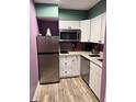 Efficient kitchen with stainless steel appliances, white cabinetry, and light countertops at 3100 Parkway Blvd # 521, Kissimmee, FL 34747