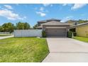 Spacious two-car garage with a long driveway and well-maintained lawn at 3221 Bayflower Ave, Harmony, FL 34773