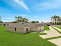 Aerial view showcasing the neighborhood's well-maintained lawns, and the home's convenient driveway at 35 Peterlee Ct, Kissimmee, FL 34758